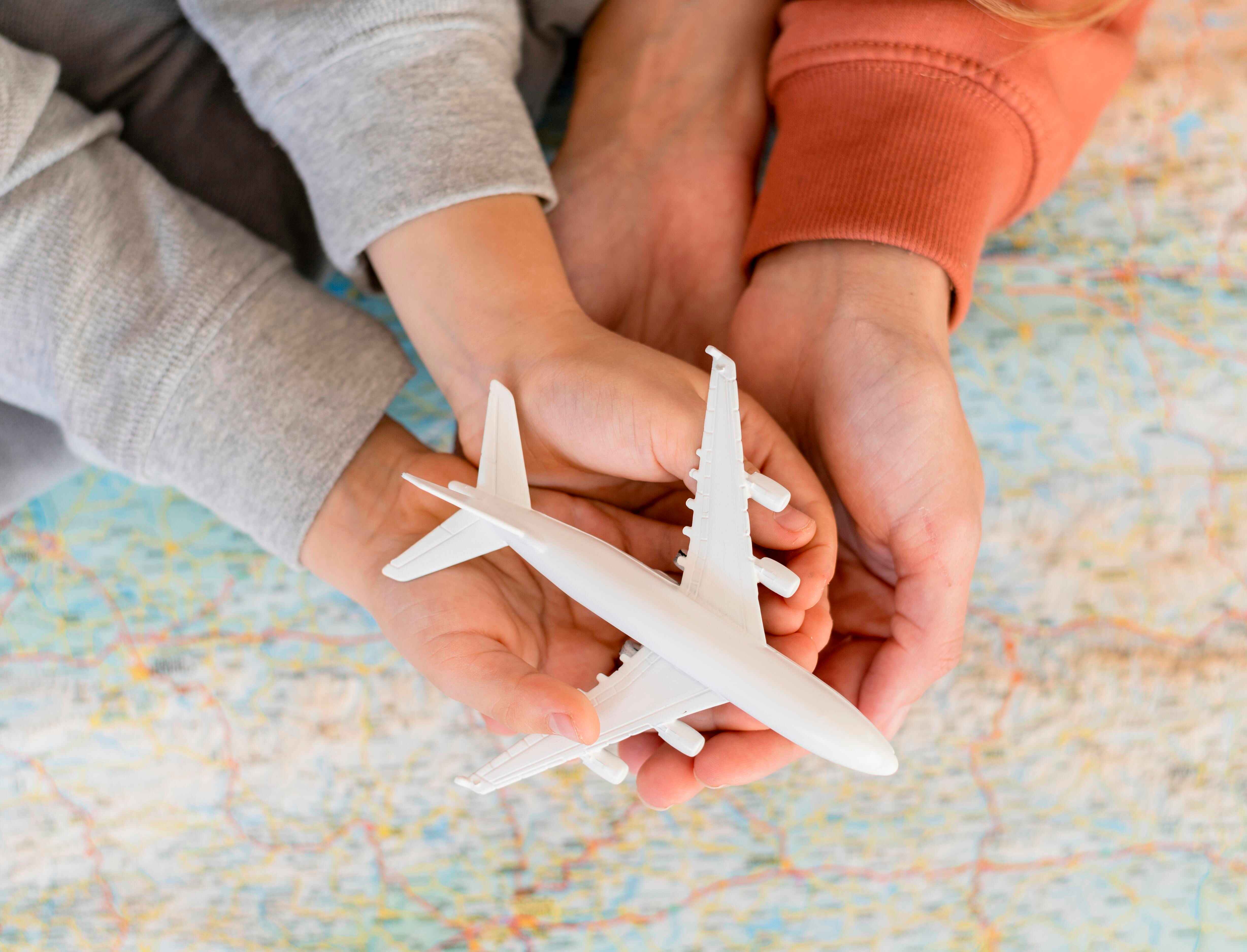 Hand holding airplane model
